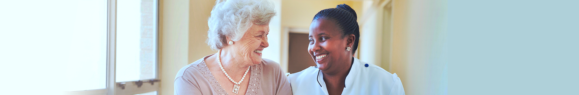 caregiver and senior woman smiling